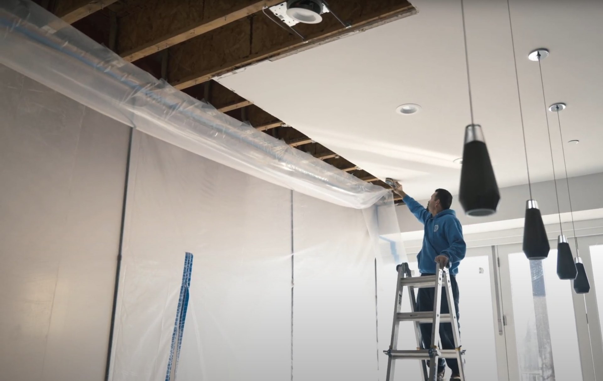 Professional water damage restoration setup with containment and drying equipment Water damage restoration equipment and protective barriers during restoration process